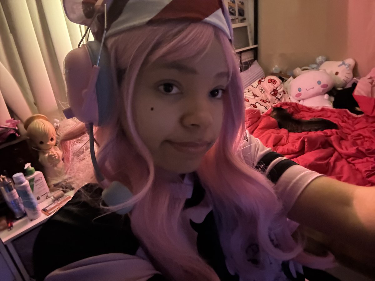 mya in a pink wig and cosplay outfit